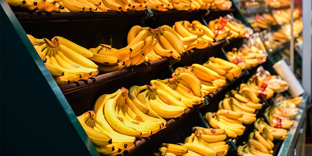 gold yellow bananas on shelf in grocery